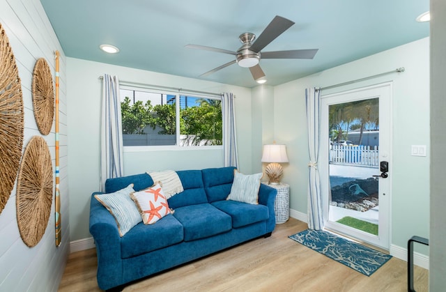 living room featuring light hardwood / wood-style flooring and ceiling fan