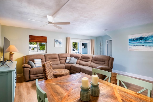 living room with hardwood / wood-style floors, ceiling fan, a wealth of natural light, and a textured ceiling