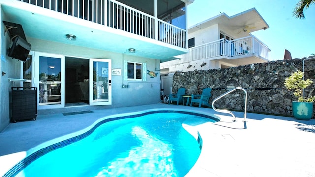 view of swimming pool featuring a patio and ceiling fan