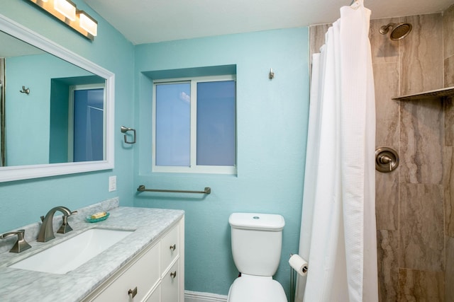 bathroom featuring a shower with curtain, vanity, and toilet