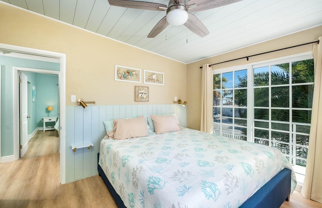 bedroom featuring wood ceiling, light hardwood / wood-style floors, and ceiling fan