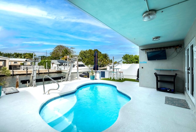 view of swimming pool featuring a water view, ceiling fan, a dock, and a patio