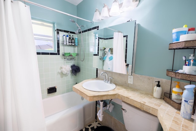 full bathroom featuring shower / bath combination with curtain, toilet, and sink