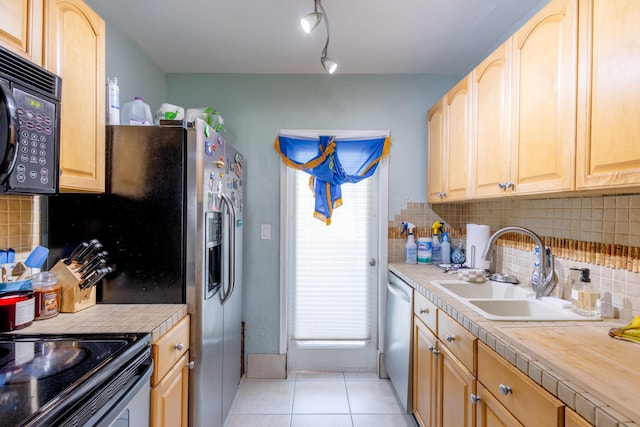 kitchen with tasteful backsplash, sink, stainless steel dishwasher, light tile patterned floors, and light brown cabinets