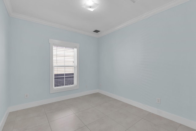 tiled spare room with crown molding