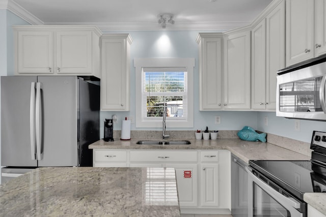 kitchen featuring crown molding, appliances with stainless steel finishes, sink, and white cabinets