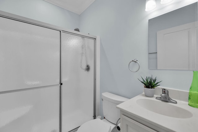 bathroom featuring walk in shower, vanity, and toilet