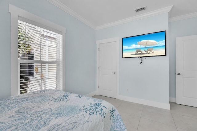 bedroom with ornamental molding and light tile patterned flooring