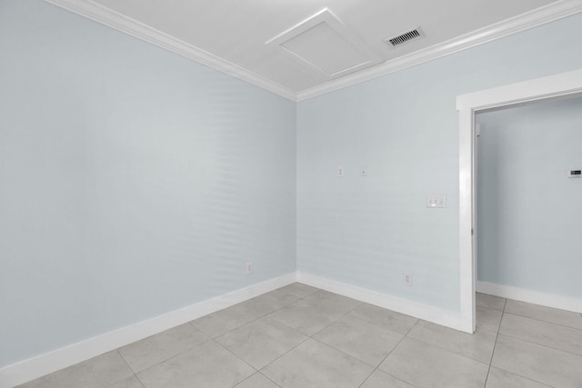 tiled spare room featuring crown molding