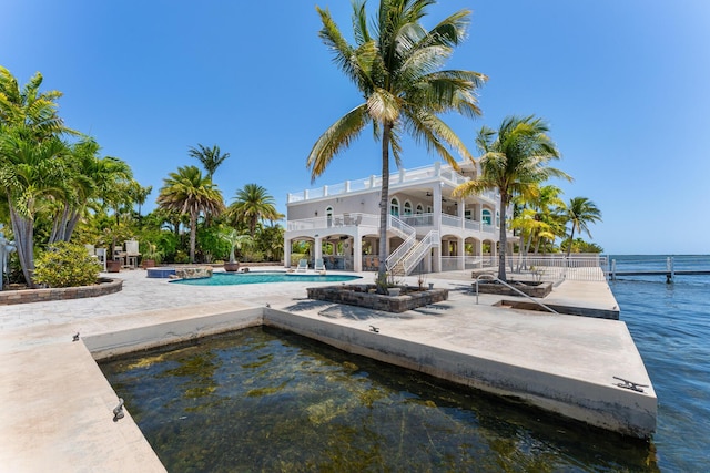 3742 Seagrape St, Big Pine, FL 33043 - swimming pool featuring a patio, a water view, stairway, and a boat dock