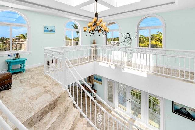 3742 Seagrape St, Big Pine, FL 33043 - stairway with a chandelier, plenty of natural light, baseboards, and a skylight