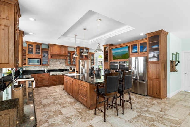 3742 Seagrape St, Big Pine, FL 33043 - kitchen featuring appliances with stainless steel finishes, a sink, a tray ceiling, backsplash, and brown cabinets