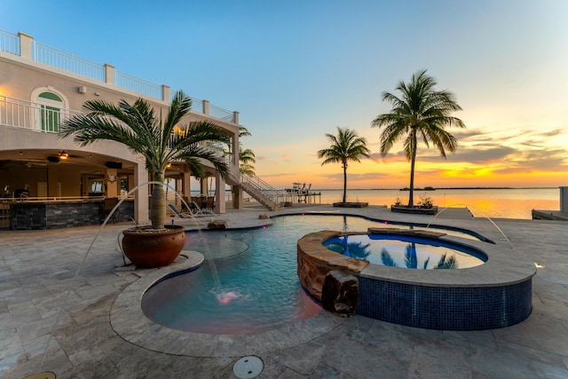 3742 Seagrape St, Big Pine, FL 33043 - pool at dusk featuring stairway, a patio area, a pool with connected hot tub, and a water view