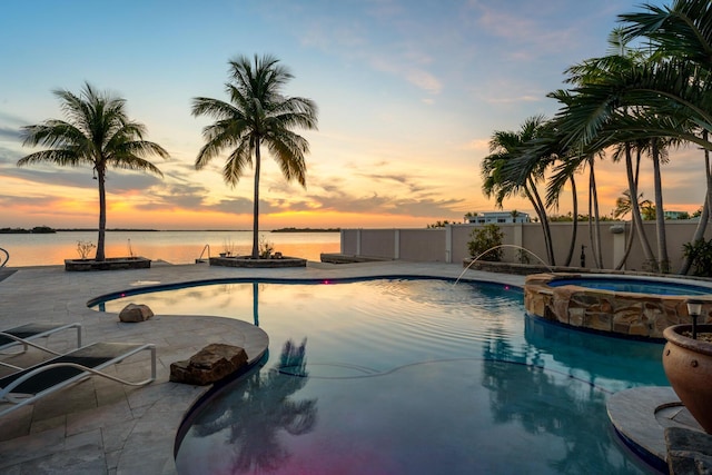 3742 Seagrape St, Big Pine, FL 33043 - view of swimming pool featuring a pool with connected hot tub, a patio, and a water view