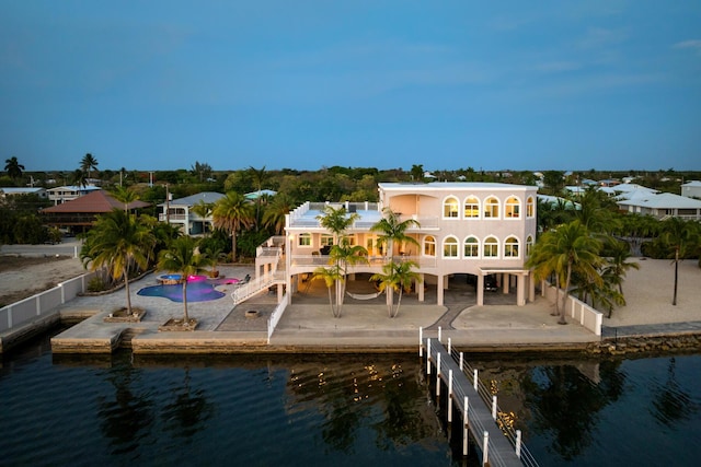 3742 Seagrape St, Big Pine, FL 33043 - rear view of house featuring a water view, a patio area, a balcony, stairs, and stucco siding