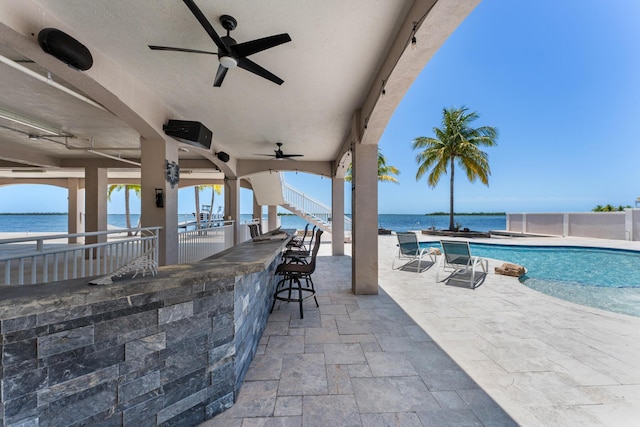 3742 Seagrape St, Big Pine, FL 33043 - view of patio / terrace featuring an outdoor bar, ceiling fan, a water view, an outdoor pool, and stairway
