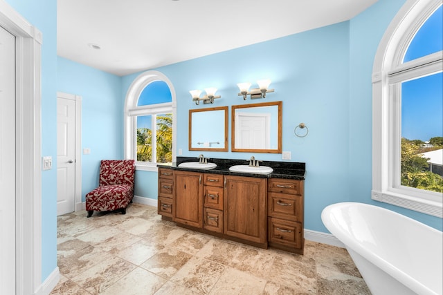 3742 Seagrape St, Big Pine, FL 33043 - full bathroom with double vanity, a soaking tub, and baseboards