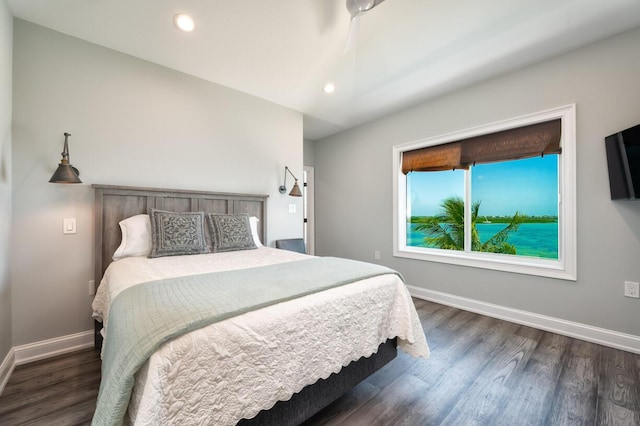 bedroom featuring dark wood-type flooring and vaulted ceiling