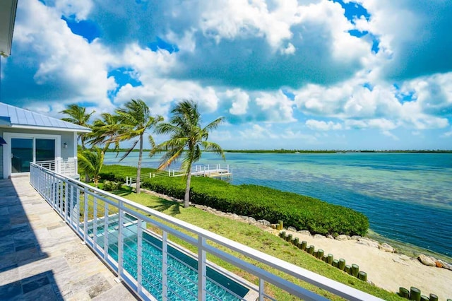 view of swimming pool featuring a water view