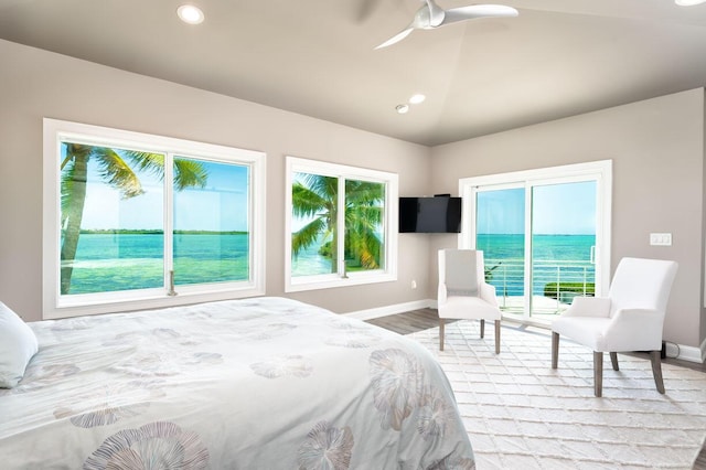 bedroom with multiple windows, access to outside, lofted ceiling, and ceiling fan