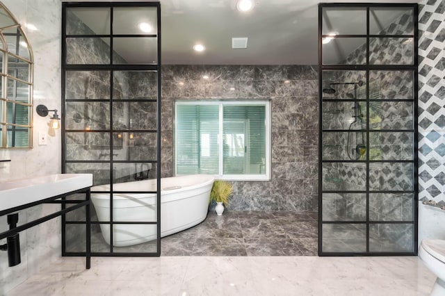 bathroom featuring a bathtub and tile walls