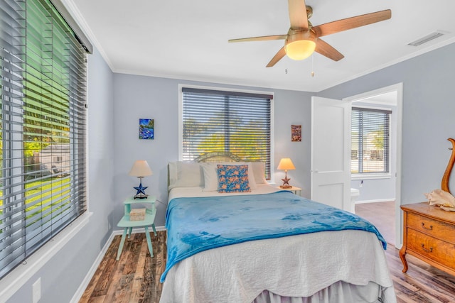 bedroom featuring ornamental molding, wood-type flooring, and ceiling fan