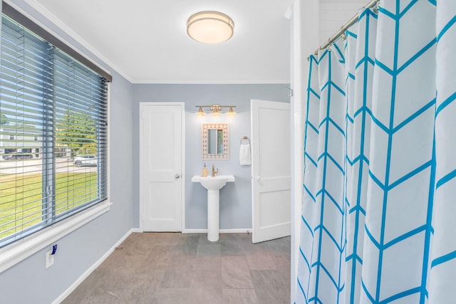 bathroom featuring crown molding and curtained shower