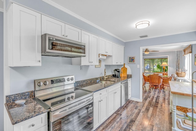 kitchen with appliances with stainless steel finishes and white cabinets