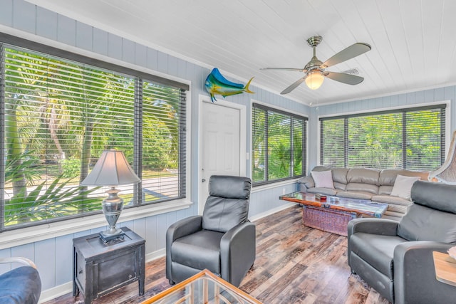 sunroom / solarium featuring ceiling fan