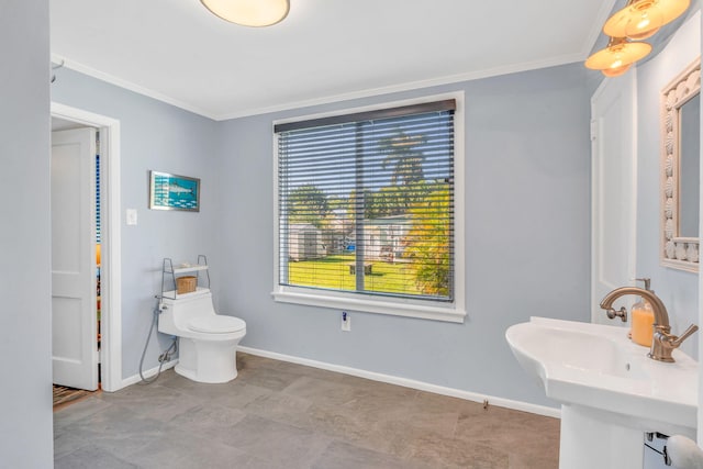 bathroom with ornamental molding, toilet, and sink