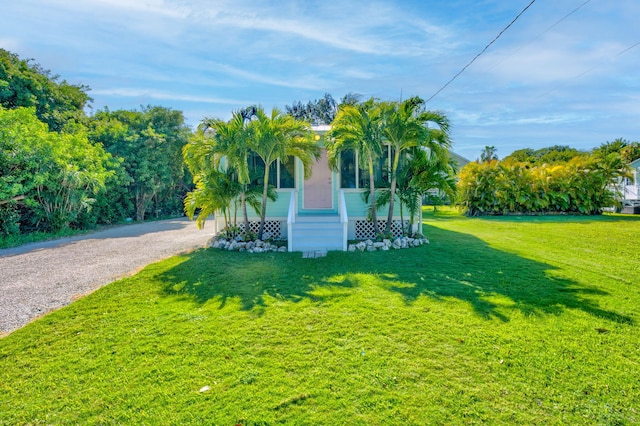 exterior space featuring covered porch and a lawn