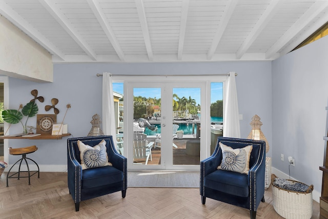 living area with parquet floors, beam ceiling, and a water view