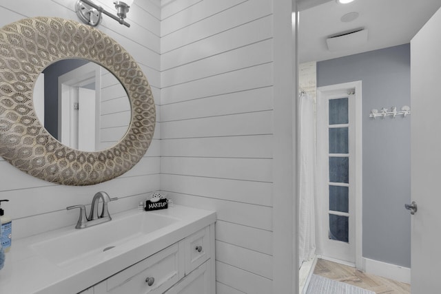 bathroom with parquet flooring and vanity