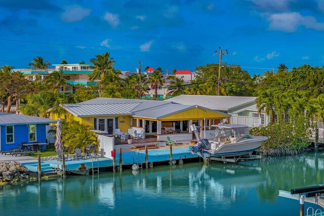 rear view of property with a water view