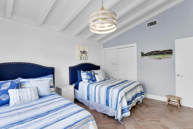 bedroom featuring an inviting chandelier, parquet flooring, lofted ceiling with beams, and a closet