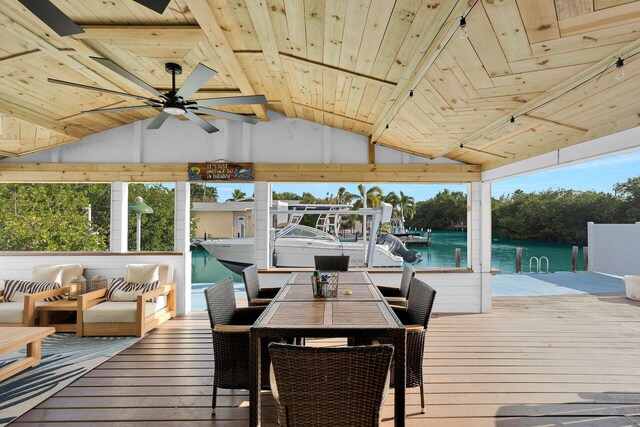 sunroom / solarium featuring vaulted ceiling, wooden ceiling, ceiling fan, and a water view