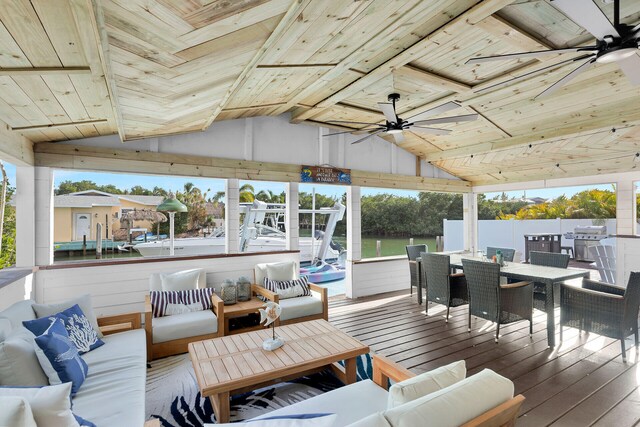 sunroom / solarium with wood ceiling, ceiling fan, and lofted ceiling