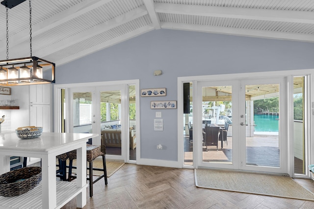 dining space with vaulted ceiling with beams, parquet flooring, and french doors