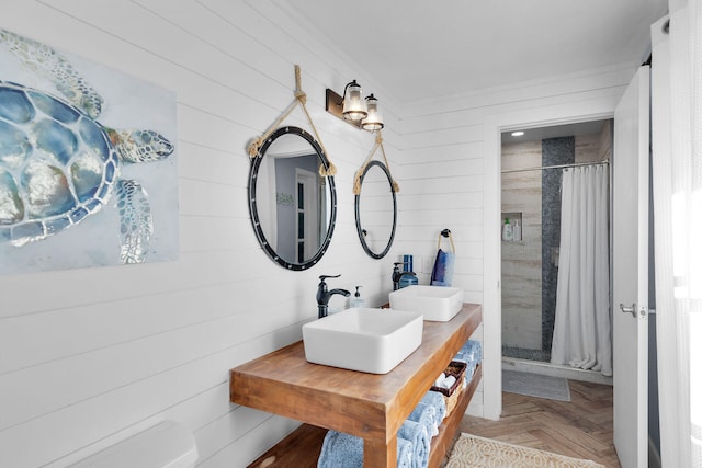 bathroom featuring parquet floors, sink, and walk in shower