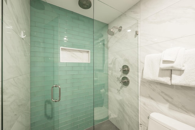 bathroom featuring toilet and walk in shower