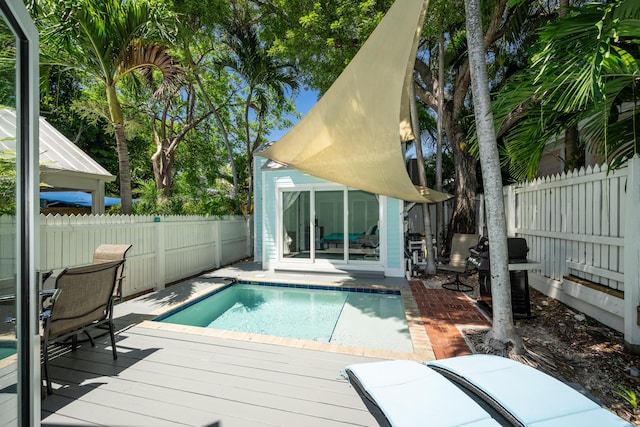 view of pool with an outdoor structure and a deck