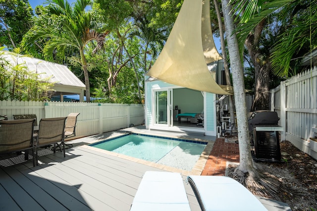 view of swimming pool featuring an outbuilding and a grill