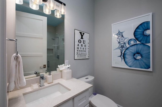 bathroom featuring vanity, an enclosed shower, and toilet