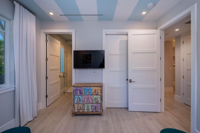 bedroom featuring light hardwood / wood-style floors and a closet