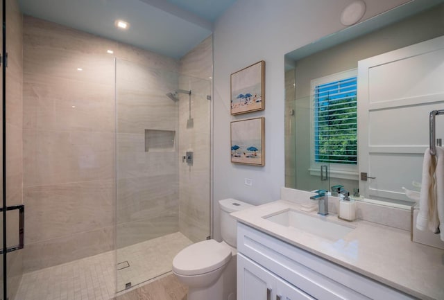 bathroom with vanity, toilet, and an enclosed shower