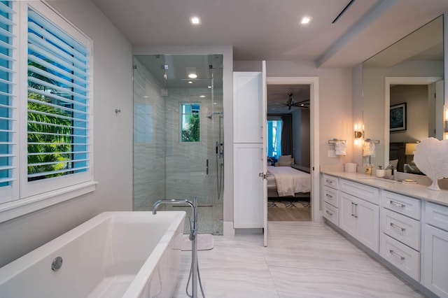 bathroom featuring vanity and separate shower and tub