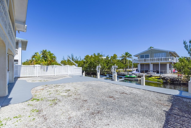 view of yard with a water view and a dock