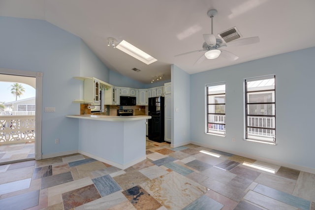 kitchen with vaulted ceiling with skylight, kitchen peninsula, white cabinetry, ceiling fan, and black appliances