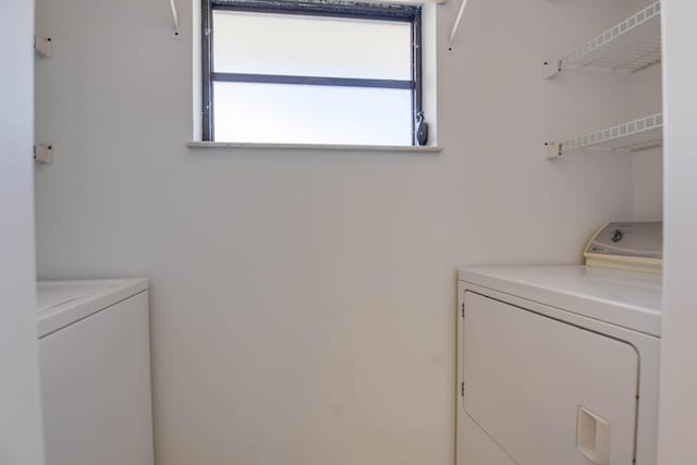 laundry room with washing machine and clothes dryer