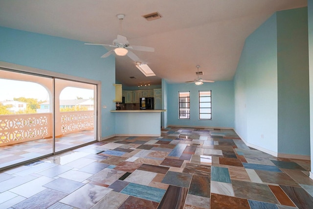 unfurnished living room with ceiling fan and high vaulted ceiling